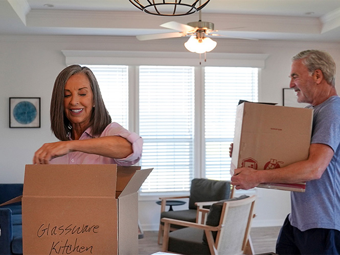 Couple unpacking boxes in their new home