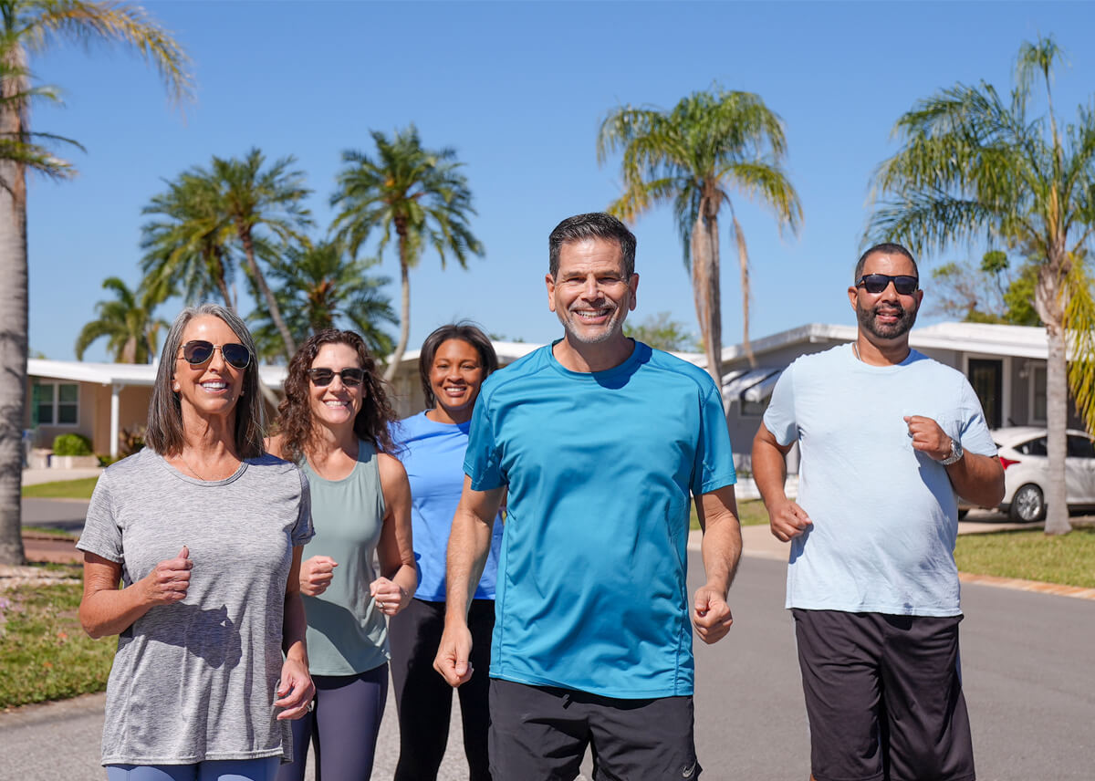 Residents standing outside near a manufactured home