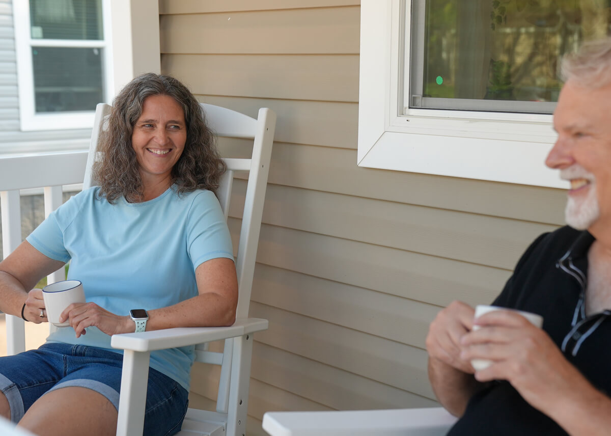 Residents standing outside near a manufactured home