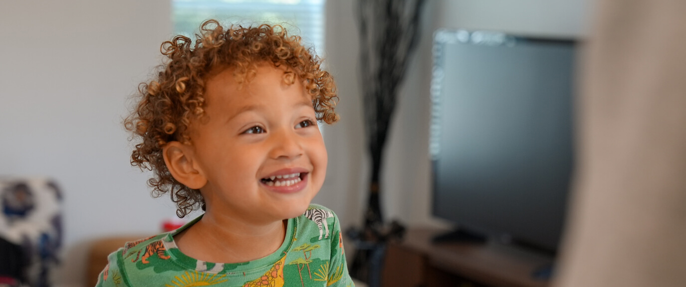 A smiling child in a home